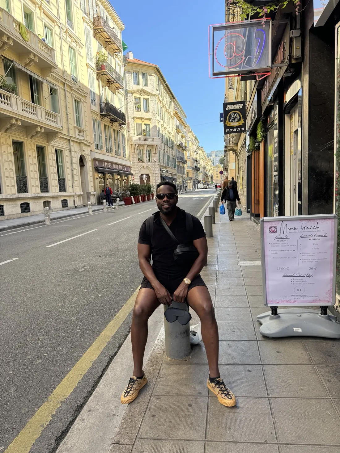 Denis enjoying a sunny city street while travelling
